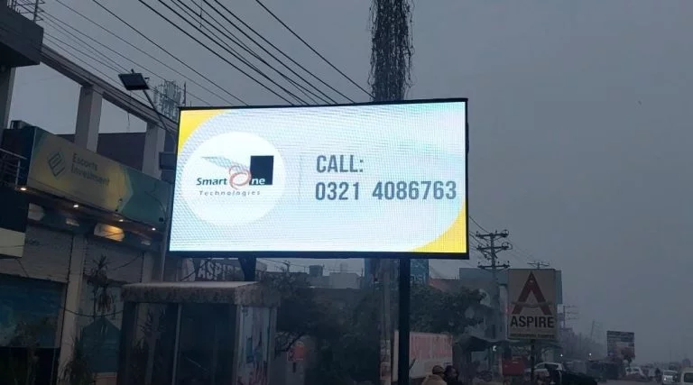 A digital roadside billboard displays an advertisement for “Smart One Technologies.” The sign includes a phone number: “Call: 0321 4086763.”