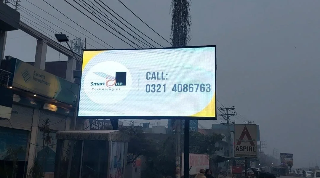 A digital roadside billboard displays an advertisement for “Smart One Technologies.” The sign includes a phone number: “Call: 0321 4086763.”