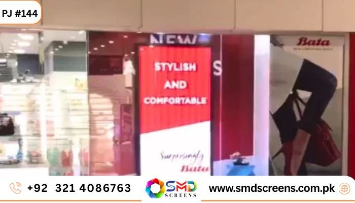 A vertical indoor LED screen inside a retail store (Bata) displaying a red advertisement with the text "STYLISH AND COMFORTABLE."