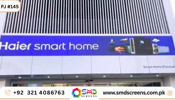 A long outdoor LED display on a white storefront façade showing the "Haier smart home" logo and various home appliances on a blue background.