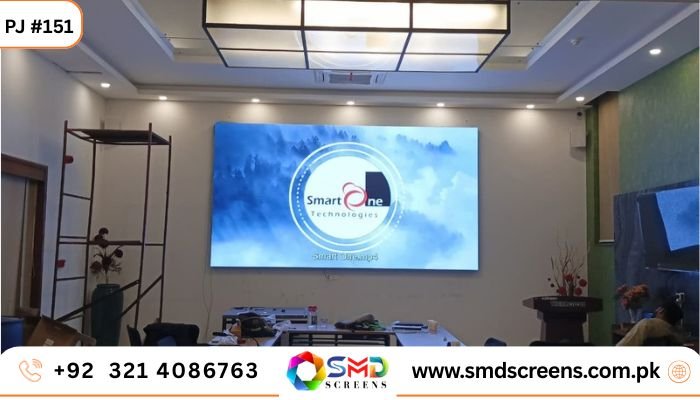 Lahore's Thermosole Industries shines with a stunning indoor SMD video wall: 4K blue-sky display of Smart One Tech logo in a modern green conference room. SMD Screens: +92 321 4086763 | smdscreens.com.pk